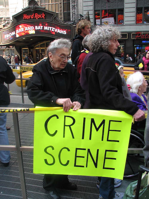 Grannies wrapping up the recruting center in Times Square with a CRIME SCERE sign